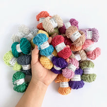 Load image into Gallery viewer, Eco-Bonbons by Nurturing Fibres many colors, with hand for scale